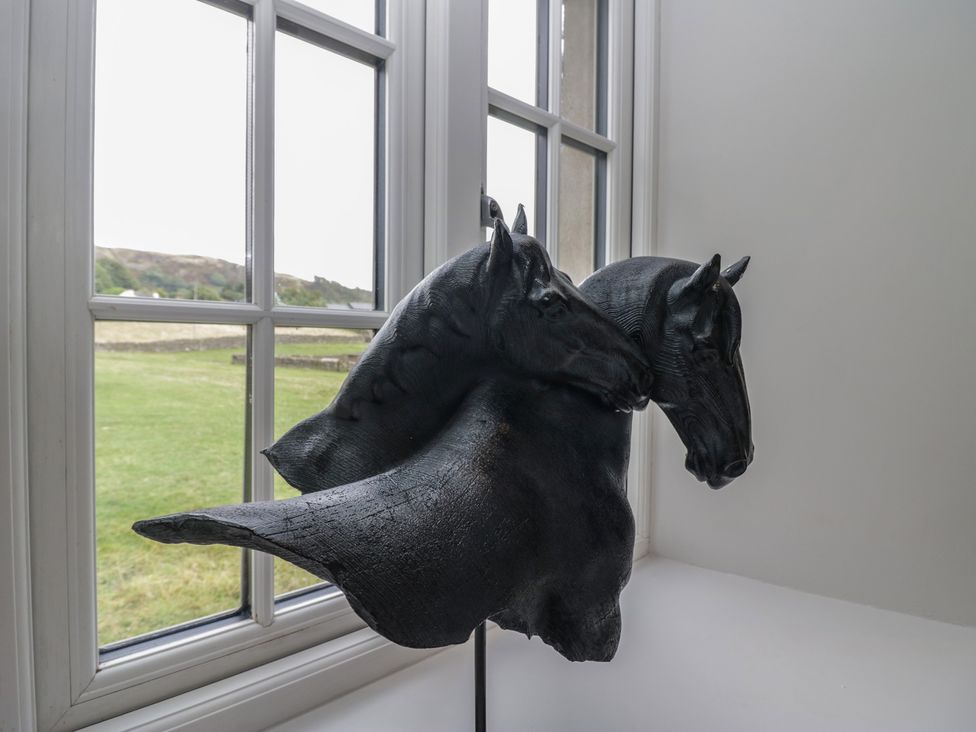 A sculpture of two horse heads in a room at Low House Cottage Ayside near Newby Bridge