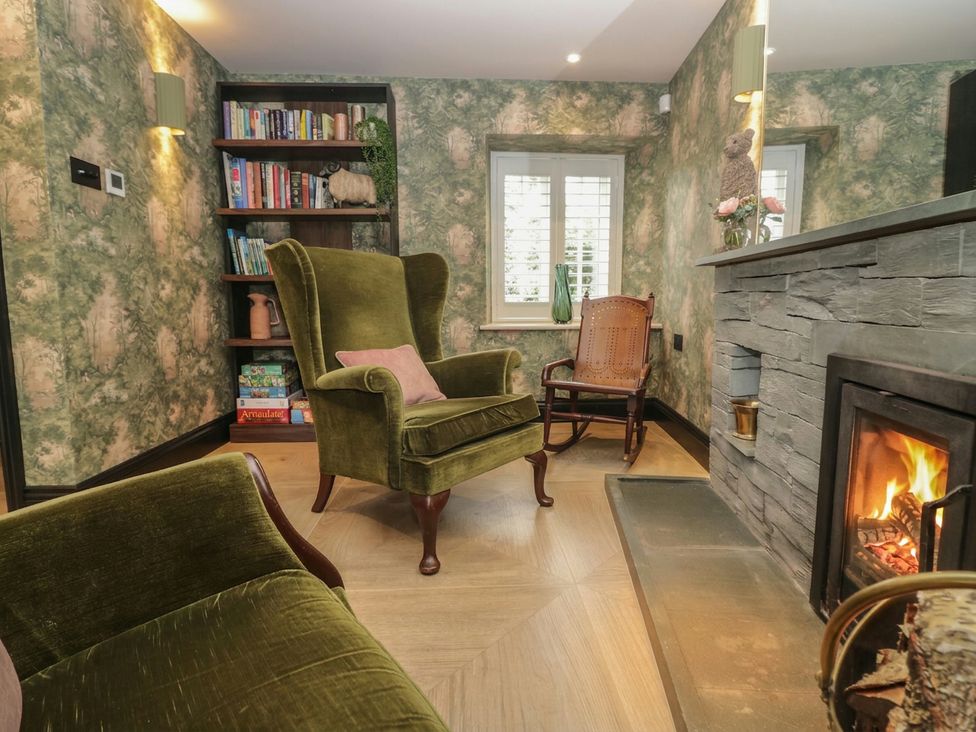 A living room with seating and a fireplace at Low House Cottage Ayside near Newby Bridge