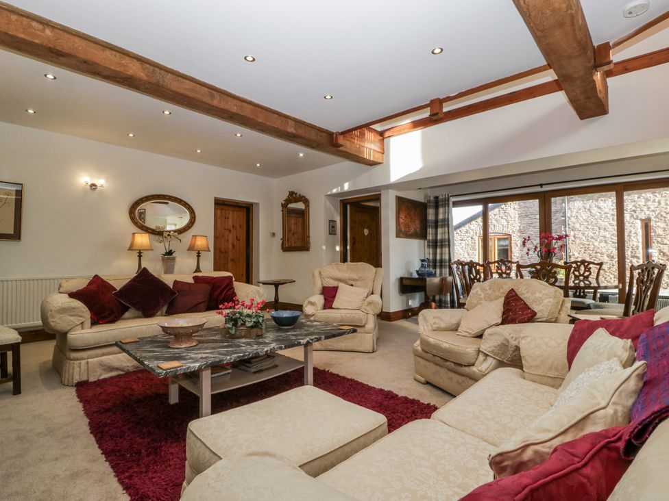 A living room with a sofa and coffee table at The Wren's Nest in Ross-on-Wye