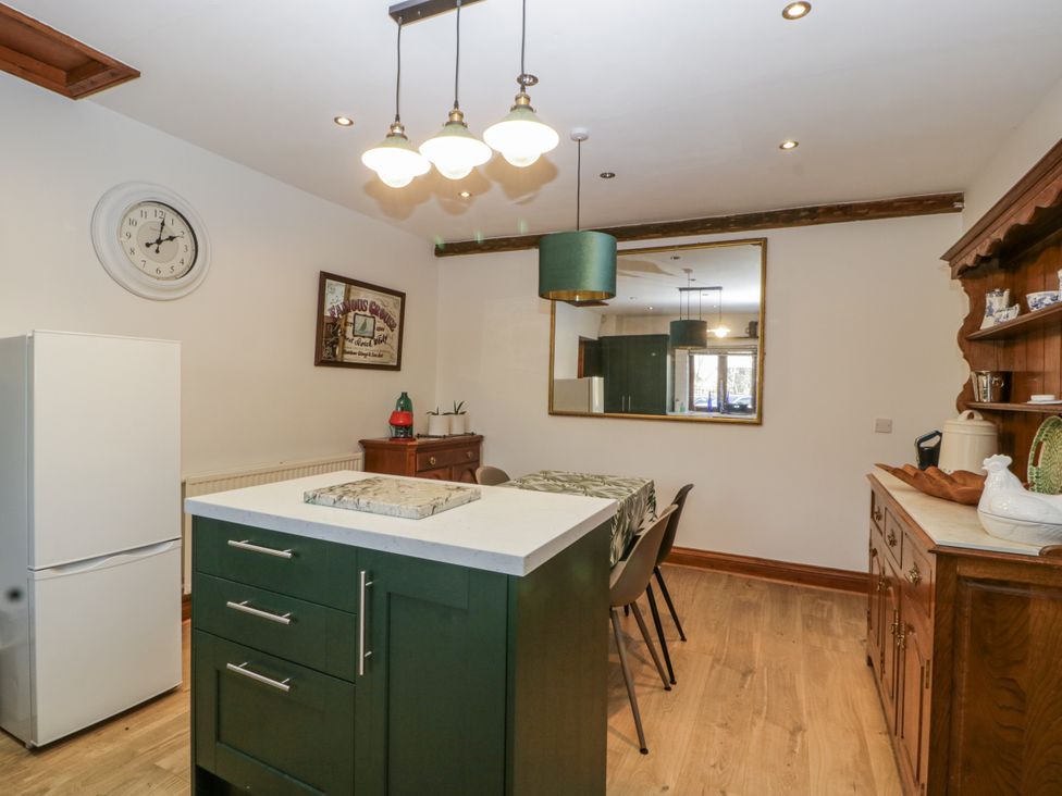 A kitchen with a table and chairs at The Wren's Nest in Ross-on-Wye