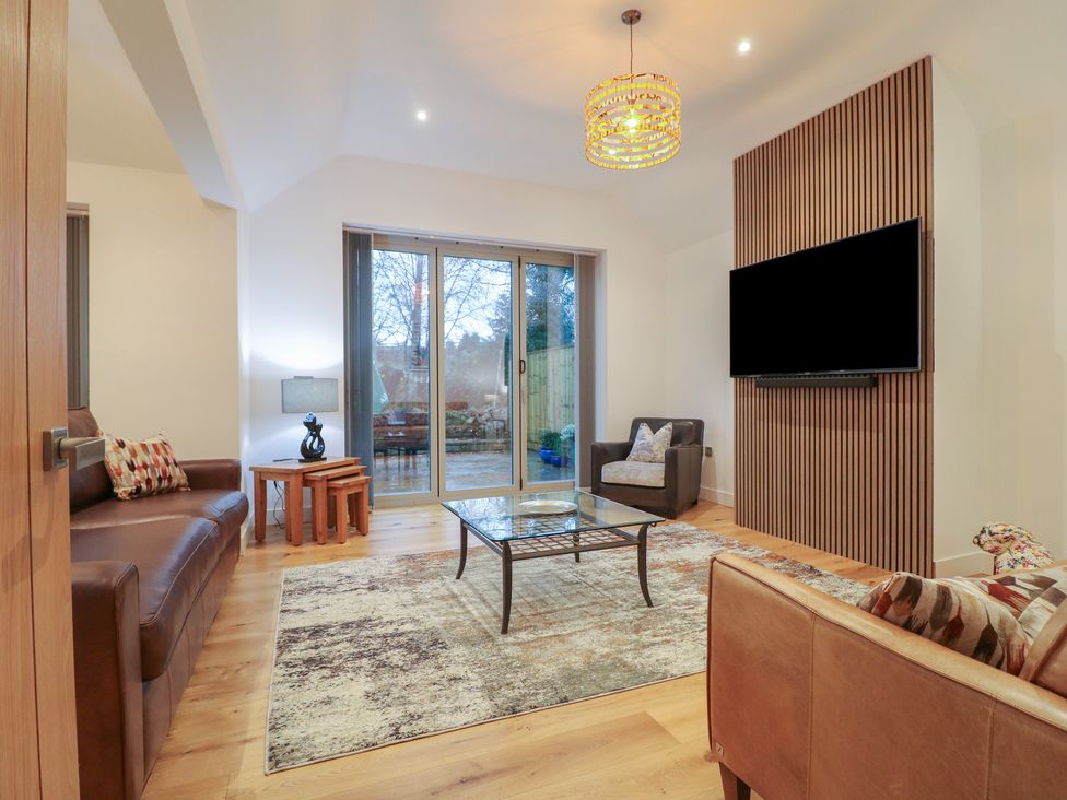 A living room with a coffee table and sofa at Oakwood Mews in Matlock