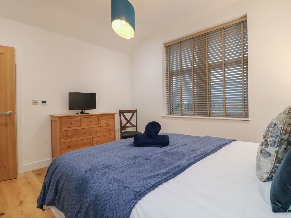 A bedroom with a bed and television at Oakwood Mews in Matlock