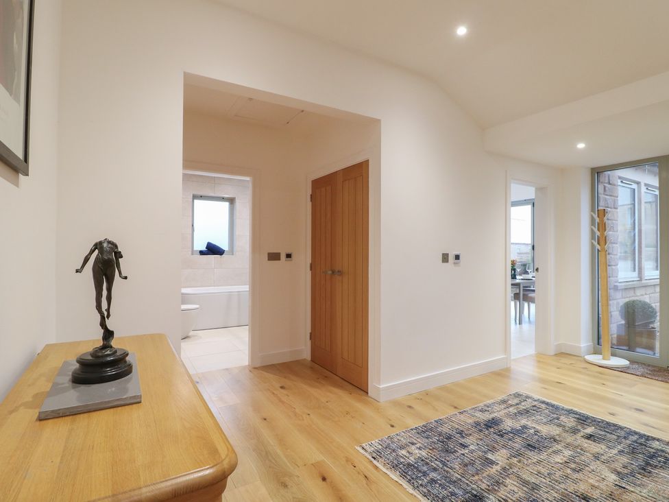 A hallway with a table and sculpture at Oakwood Mews Matlock