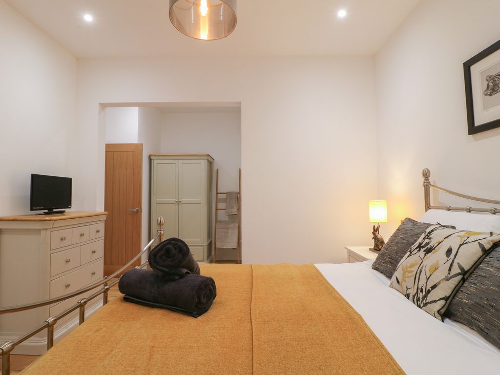 A bedroom with a bed and television at Oakwood Mews Matlock