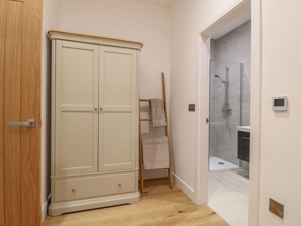 A bathroom with a shower and wardrobe at Oakwood Mews in Matlock