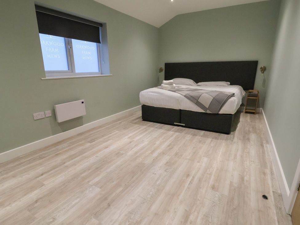 A bedroom with a bed and bedside table at Willow Barn in Chester