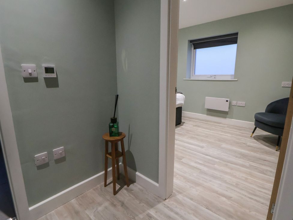 A bedroom with light switches and a stool at Willow Barn in Chester