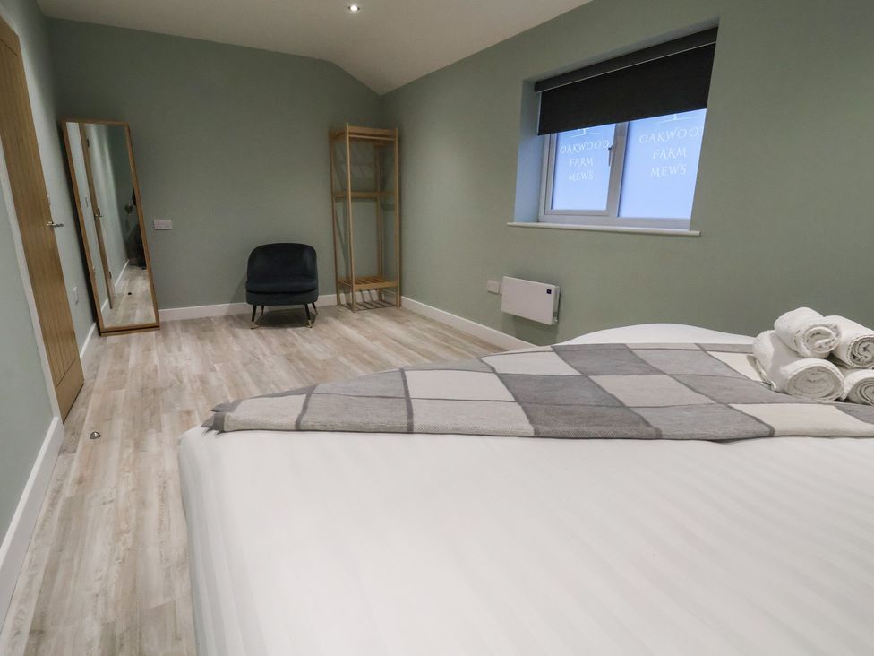 A bedroom with a bed and a chair at Willow Barn Chester