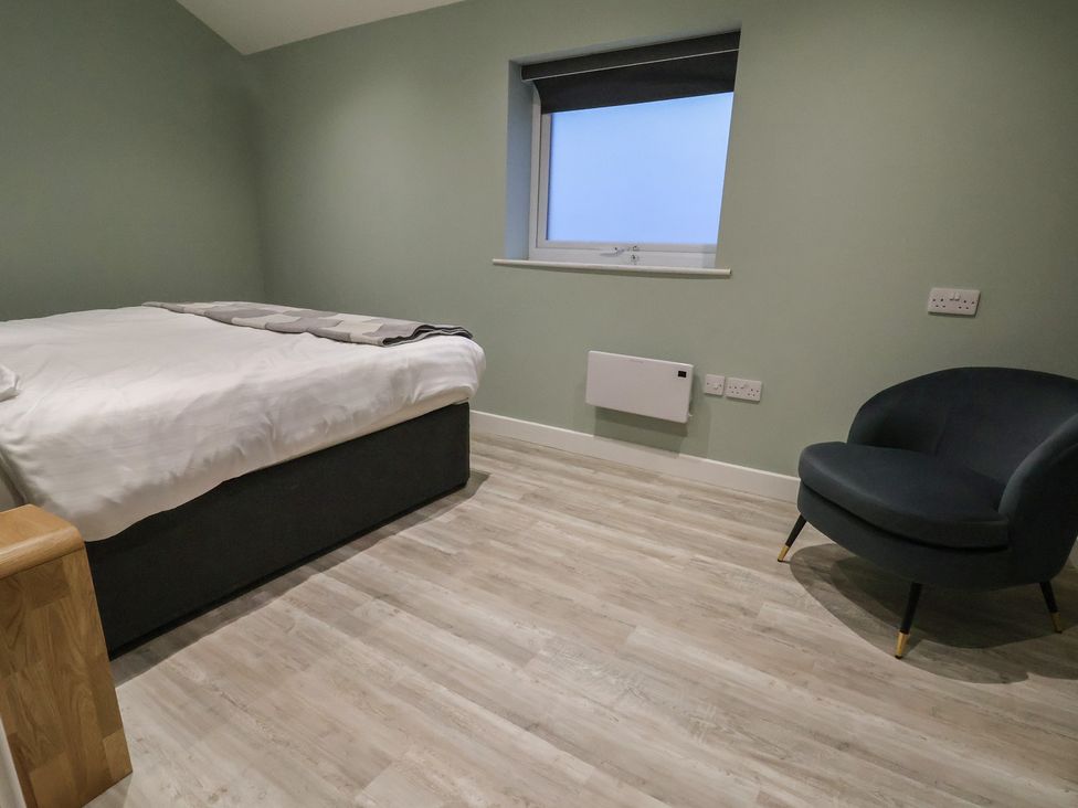 A bedroom with a bed and chair at Willow Barn in Chester