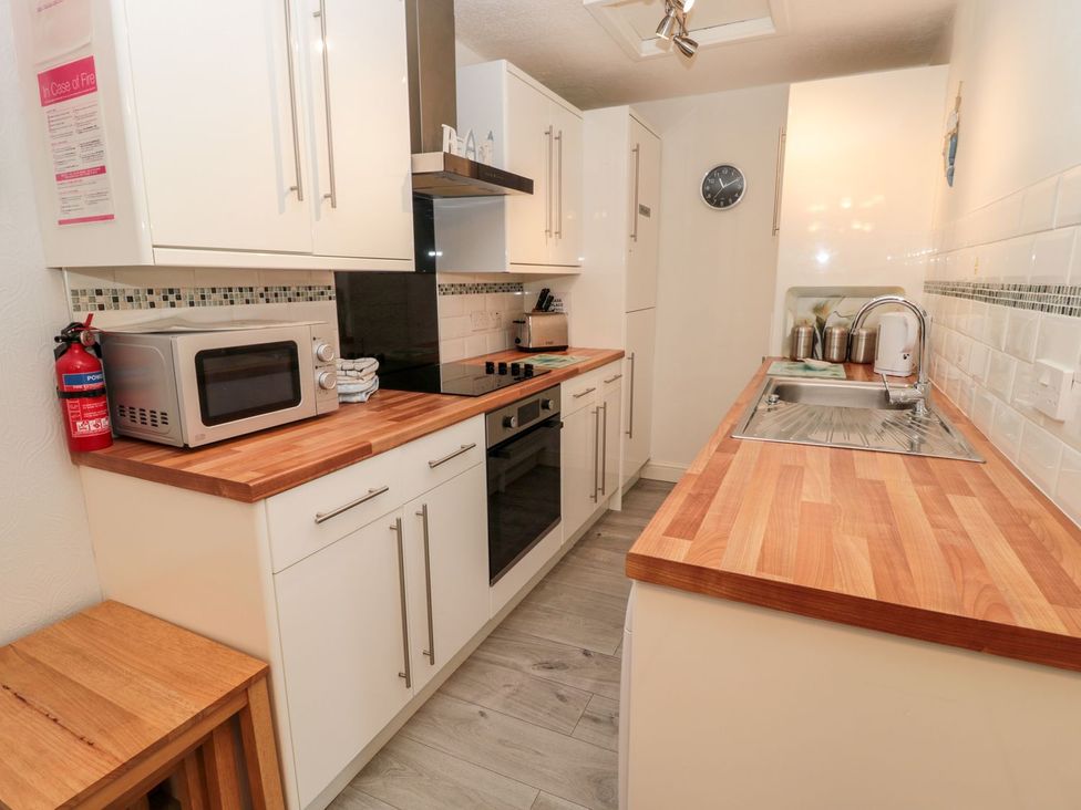 A kitchen with appliances and countertops at Primrose Cottage in Chathill