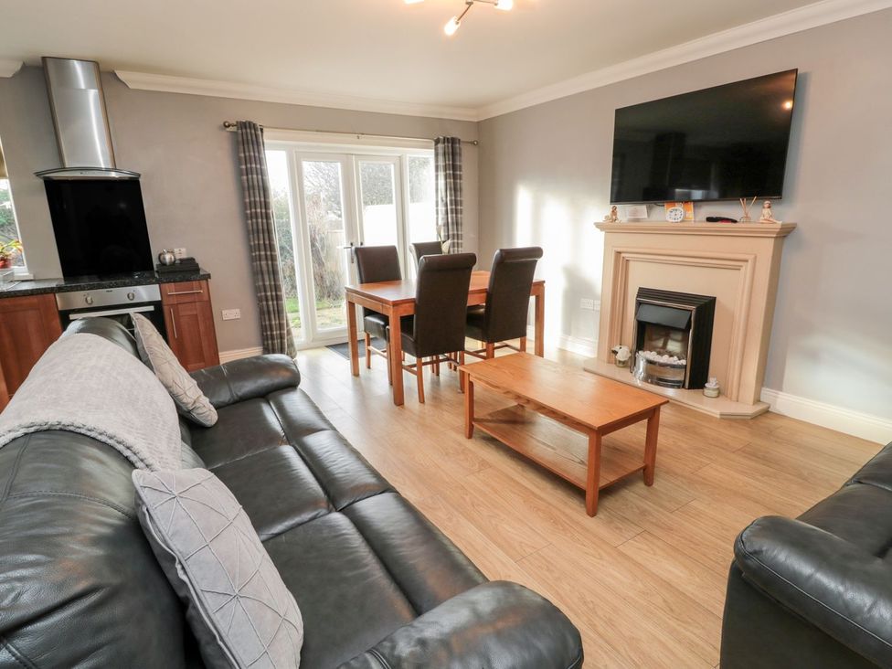 A living room with sofa and dining table at Megstone in Chathill