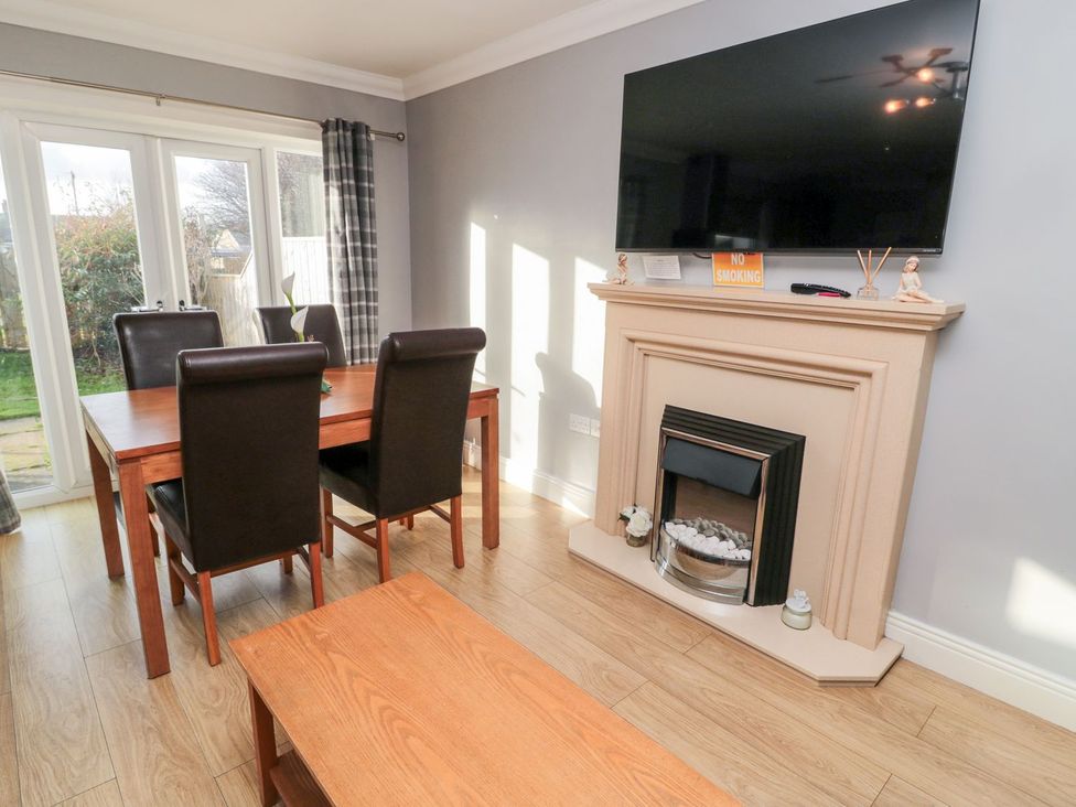 A dining room with a table and chairs at Megstone in Chathill