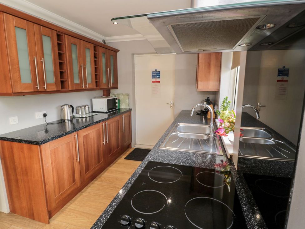 A kitchen with cabinets and appliances at Megstone in Chathill