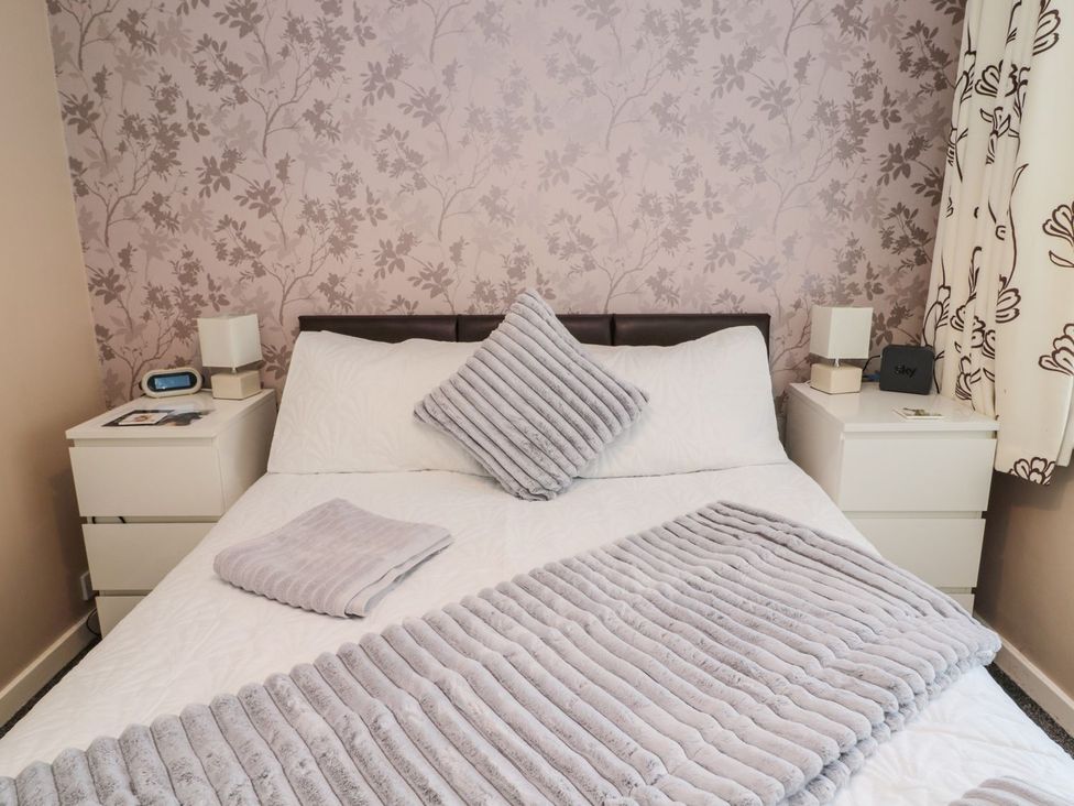 A bedroom with a bed and bedside tables at Megstone in Chathill