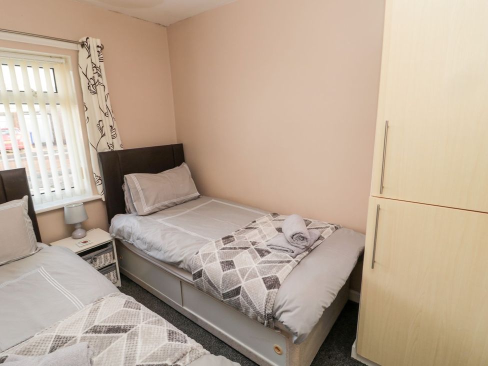 A bedroom with two beds and a wardrobe at Megstone in Chathill