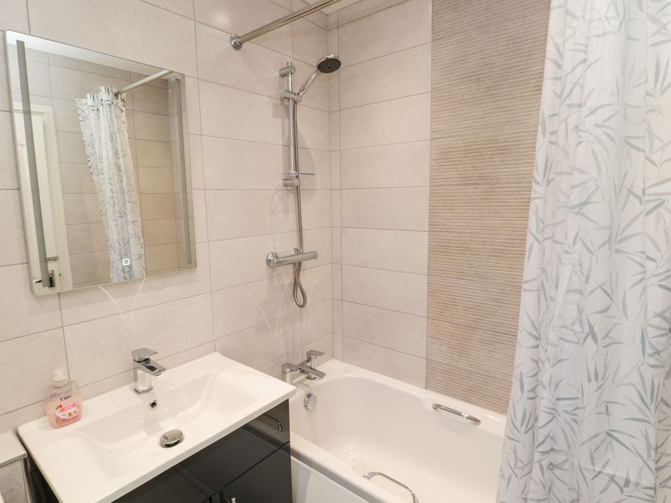 A bathroom with a bathtub and shower at Megstone in Chathill
