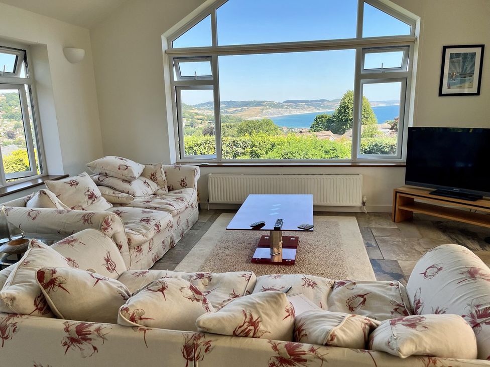 A living room with a view of the coast at Hawksdown in Lyme Regis