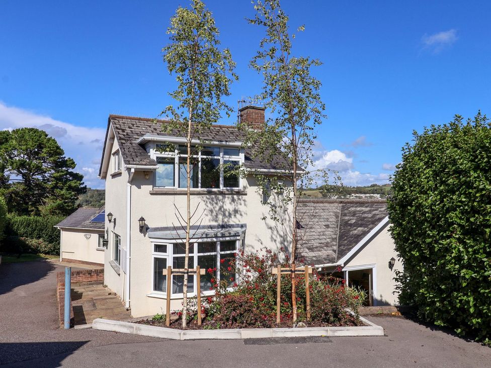 A house with trees and shrubs at Hawksdown in Lyme Regis