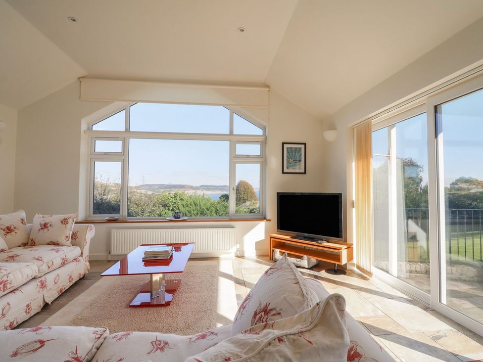 A living room with a sofa and television at Hawksdown in Lyme Regis
