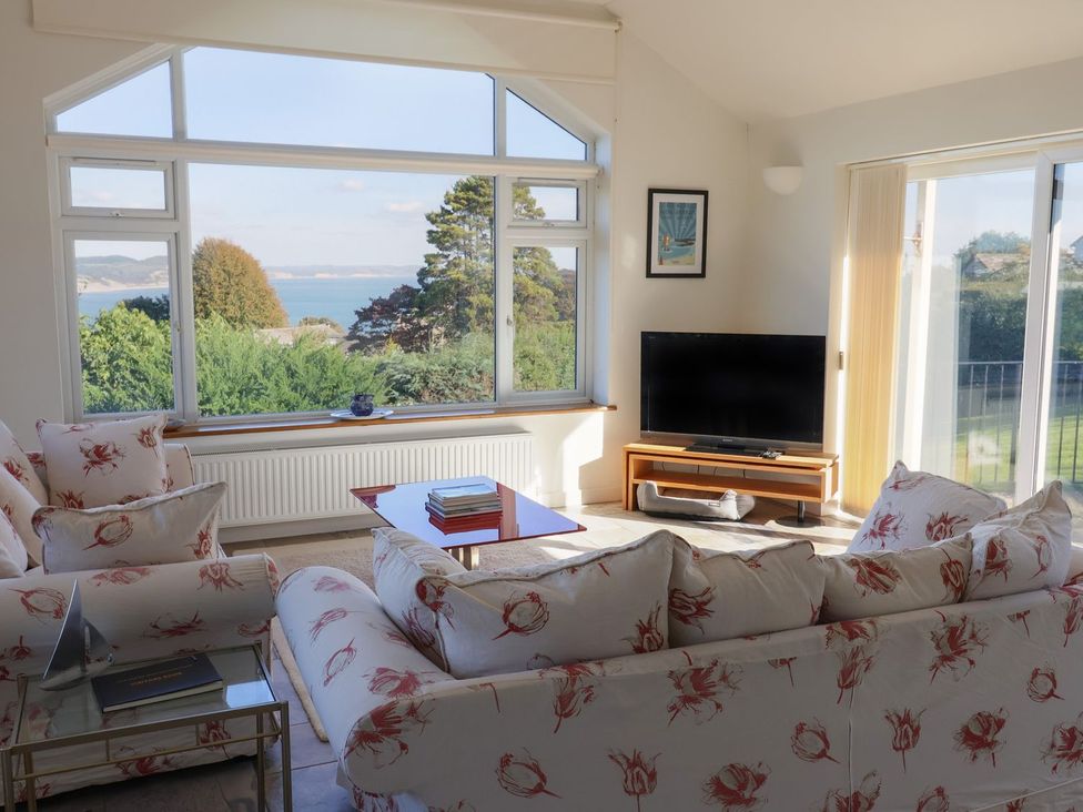 A living room with a sofa and television at Hawksdown in Lyme Regis