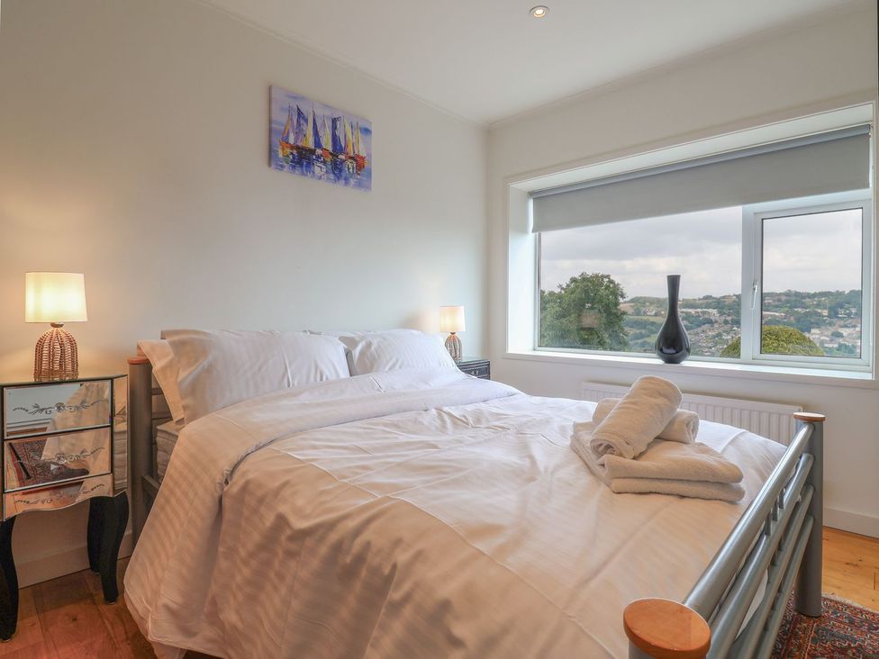 A bedroom with a bed and bedside table at Hawksdown in Lyme Regis
