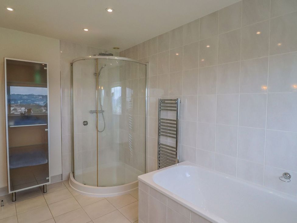 A bathroom with a shower and bath tub at Hawksdown in Lyme Regis