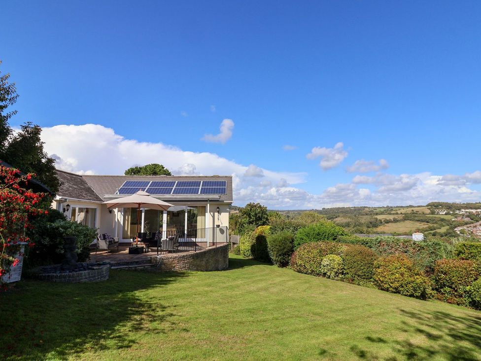 A house with solar panels and a garden at Hawksdown Lyme Regis