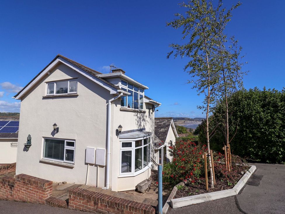 An exterior view of a house with trees and landscaping at Hawksdown Lyme Regis