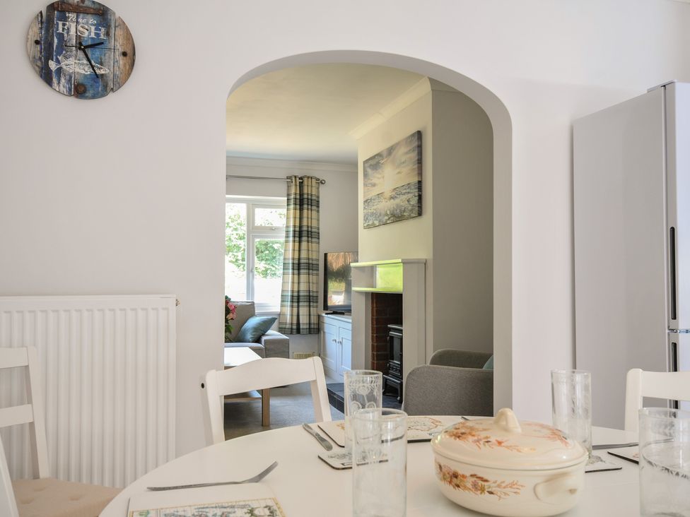 A dining room with a table and chairs at Jazmine in Dacre
