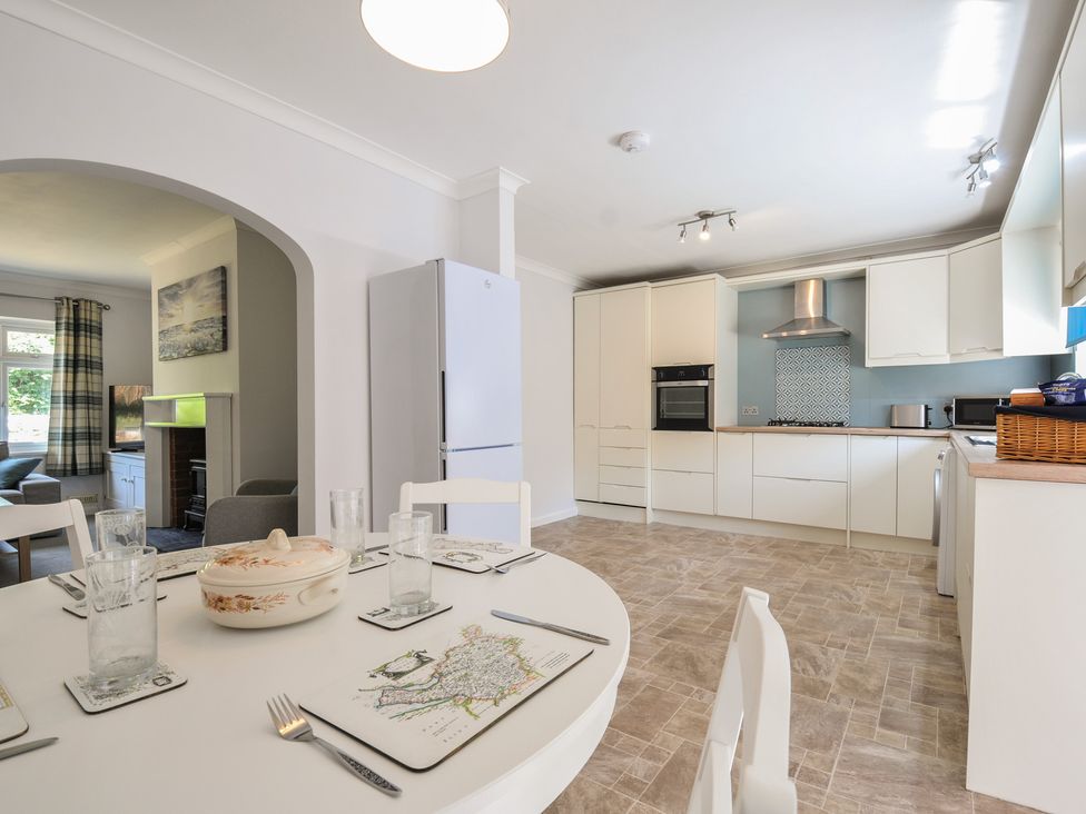 A kitchen with a dining table and chairs at Jazmine in Dacre