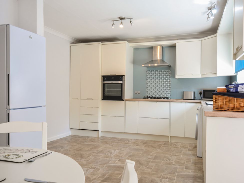 A kitchen with appliances and cabinets at Jazmine in Dacre