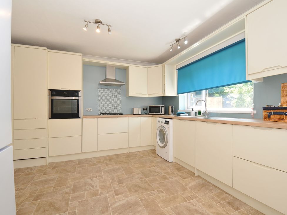 A kitchen with cabinets and appliances at Jazmine in Dacre