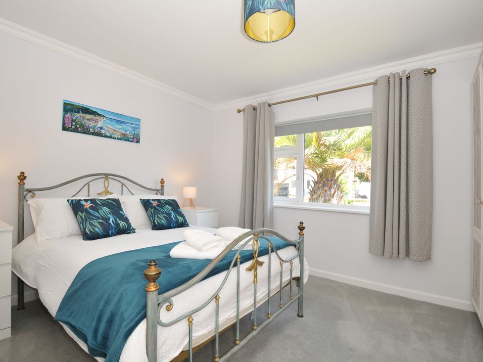A bedroom with a bed and window at Jazmine in Dacre