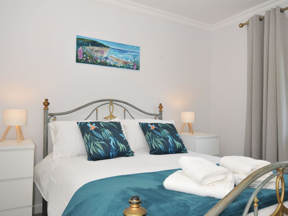 A bedroom with a bed and bedside tables at Jazmine in Dacre