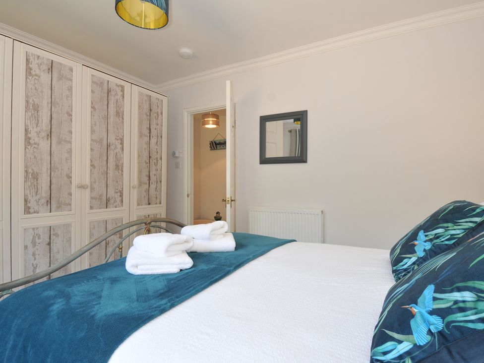 A bedroom with a bed and wardrobe at Jazmine in Dacre