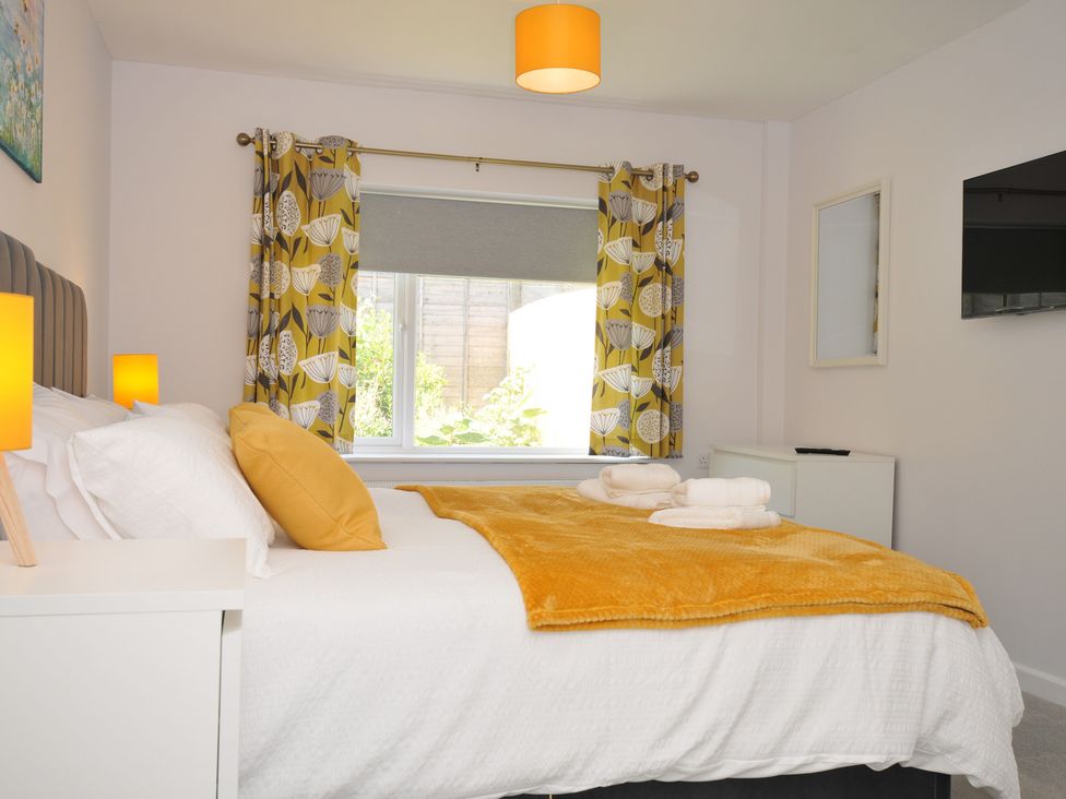 A bedroom with a bed and window at Jazmine in Dacre
