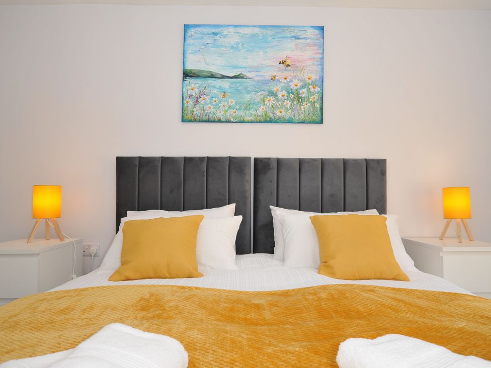 A bedroom with a bed and lamps at Jazmine in Dacre