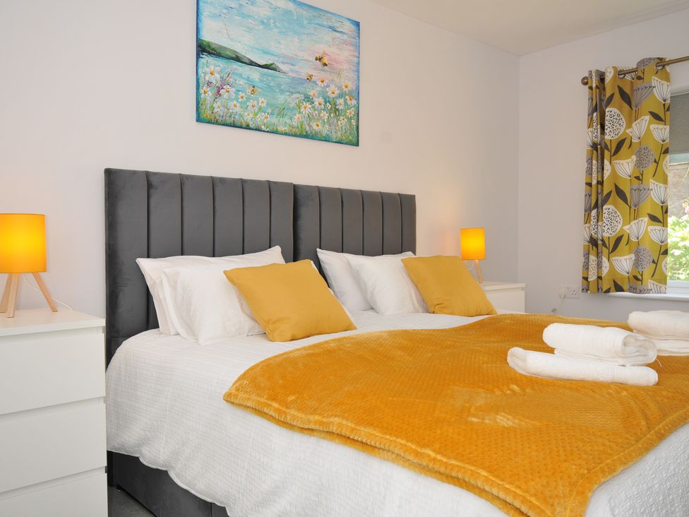 A bedroom with a bed and nightstand at Jazmine in Dacre