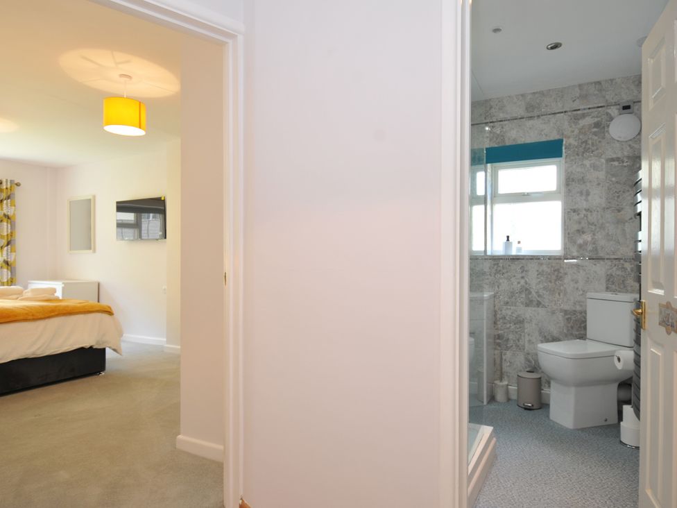 A bedroom with a view into a bathroom at Jazmine in Dacre