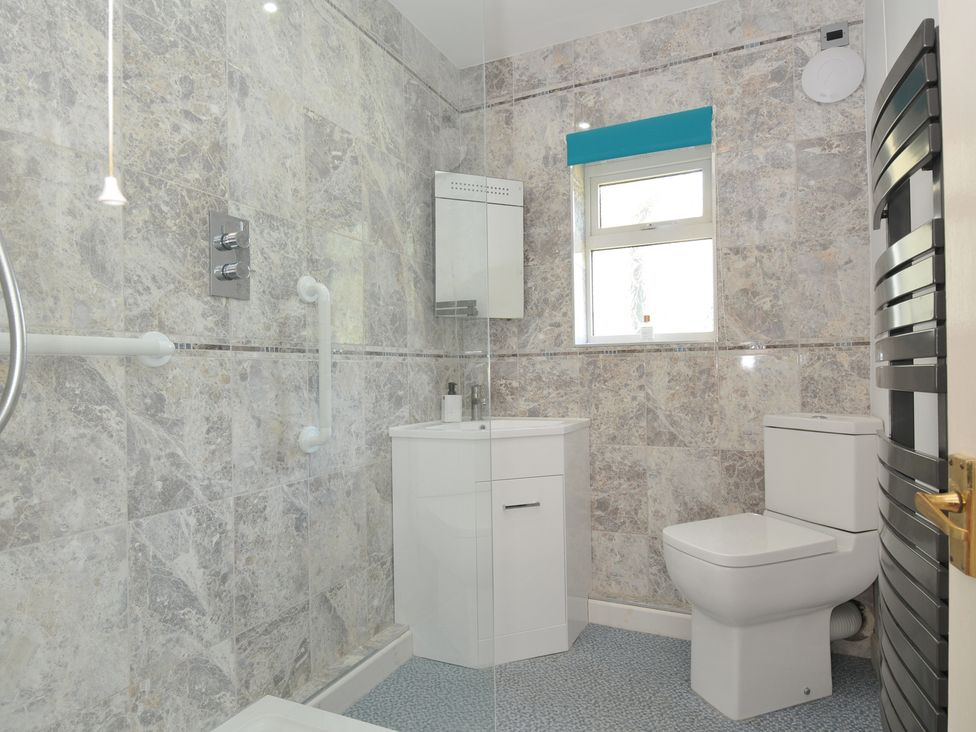 A bathroom with a shower, toilet, and sink at Jazmine in Dacre