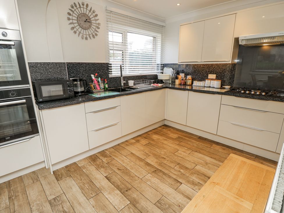 A kitchen with a microwave and stove at Red Brick Haven East Cowes, Isle Of Wight