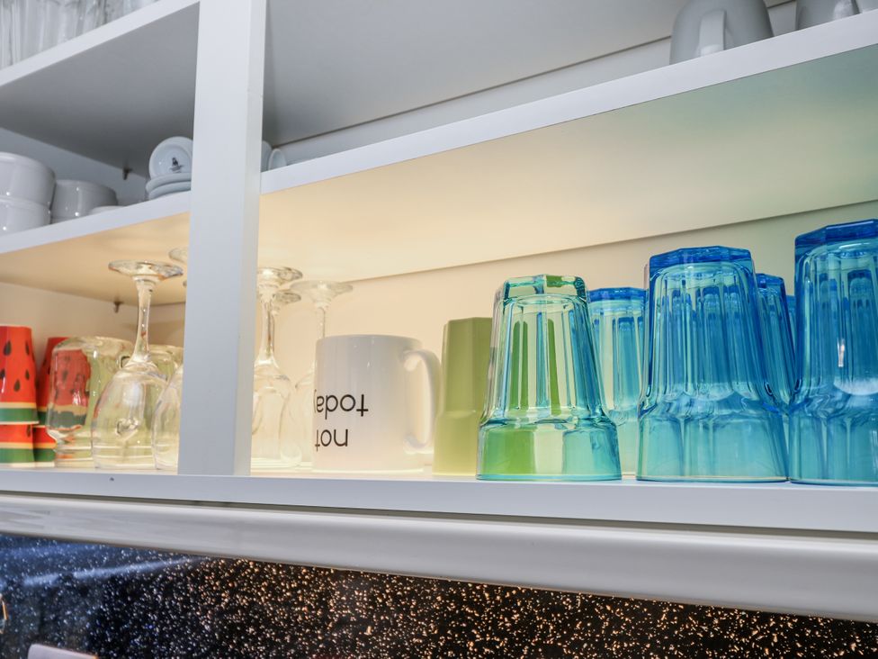 A shelf with various glasses and mugs at Red Brick Haven in East Cowes, Isle Of Wight