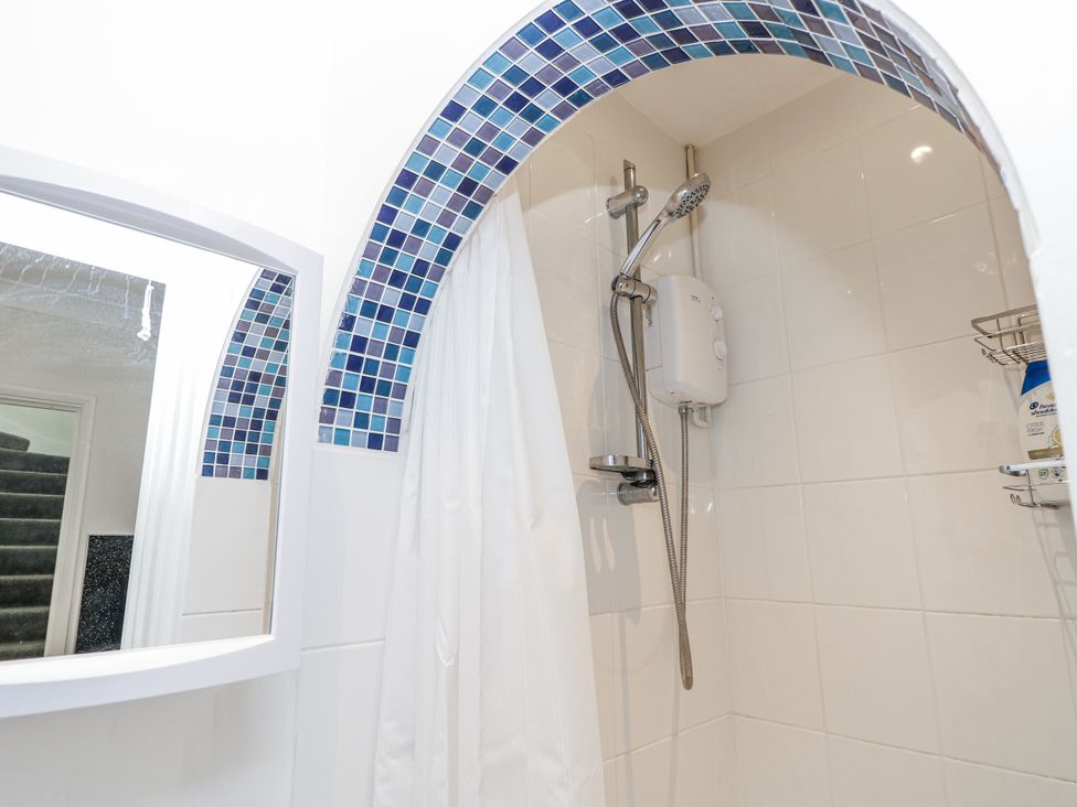 A shower with tiles and mirror at Red Brick Haven East Cowes, Isle Of Wight