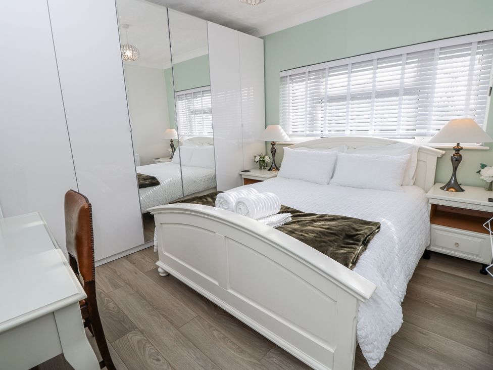 A bedroom with a bed and wardrobe at Red Brick Haven East Cowes, Isle Of Wight