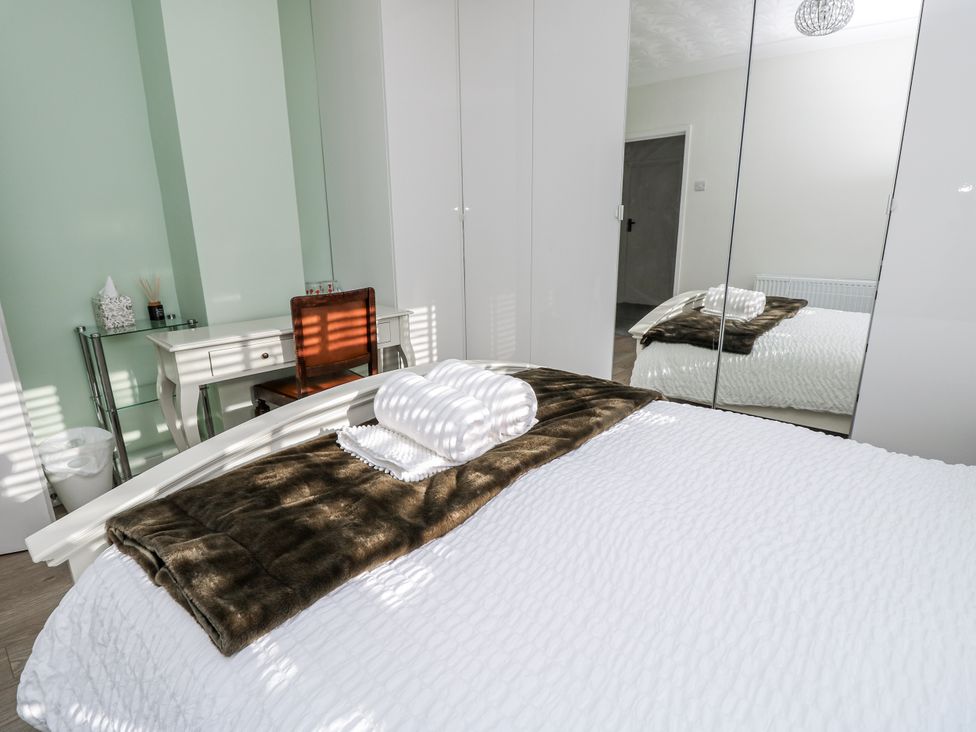 A bedroom with a bed and desk at Red Brick Haven East Cowes, Isle Of Wight