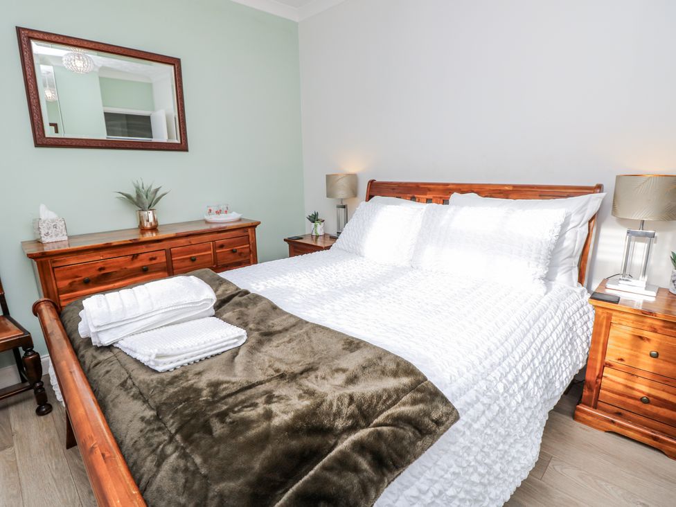 A bedroom with a bed and dresser at Red Brick Haven in East Cowes, Isle Of Wight