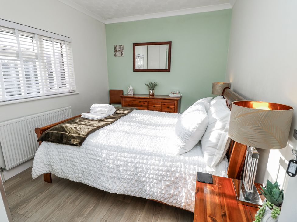 A bedroom with a bed and furniture at Red Brick Haven in East Cowes, Isle Of Wight