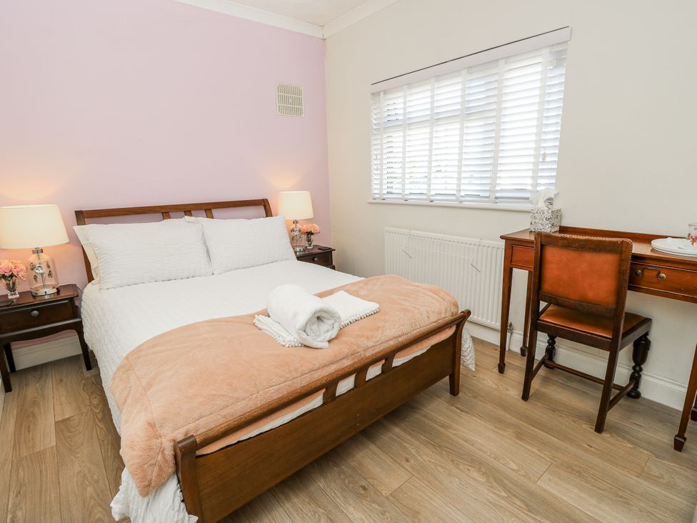 A bedroom with a bed and desk at Red Brick Haven East Cowes, Isle Of Wight