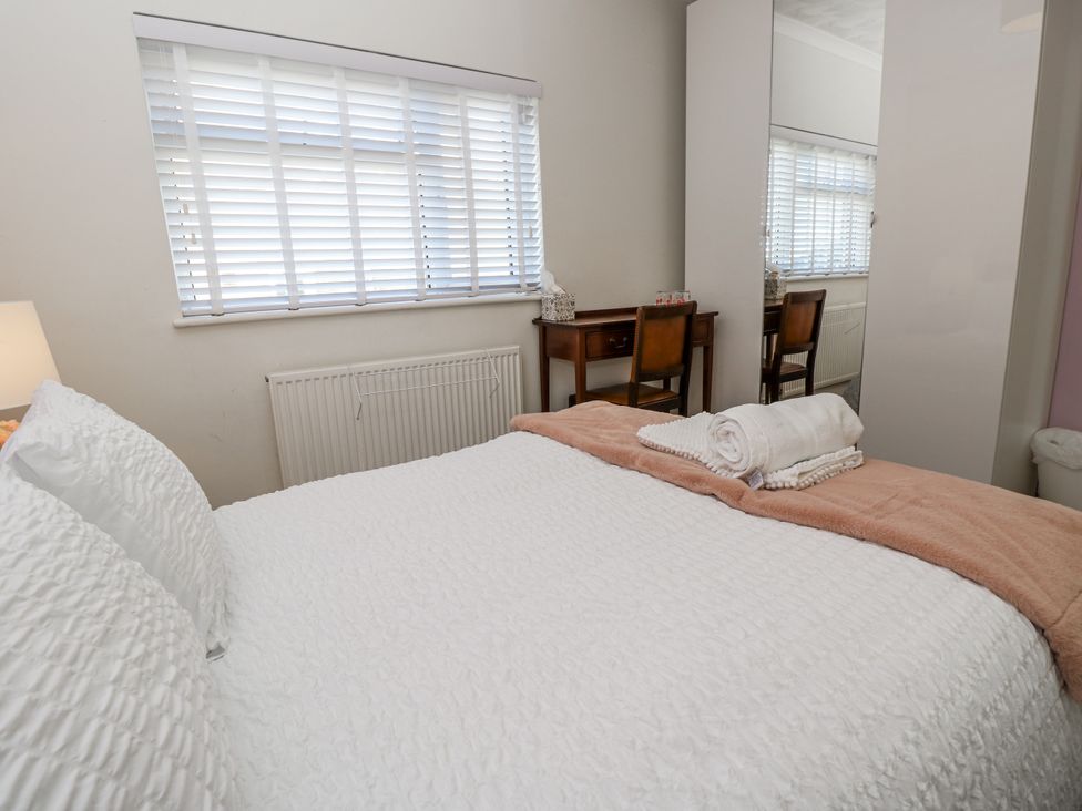 A bedroom with a bed and dresser at Red Brick Haven East Cowes, Isle Of Wight