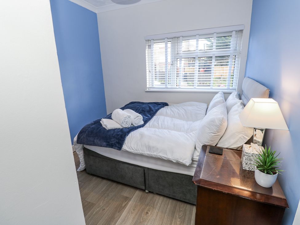 A bedroom with a bed and lamp at Red Brick Haven East Cowes, Isle Of Wight